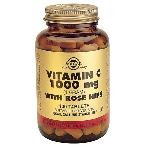 Tablet form of vitamin C supplements in a bottle.